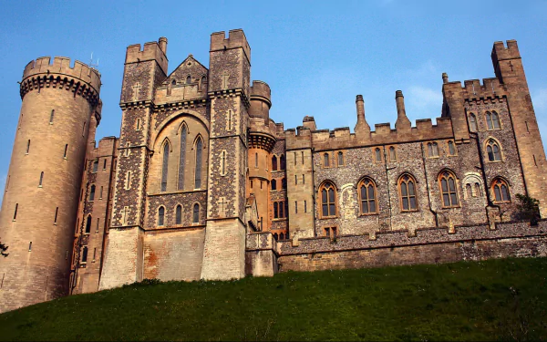Man-made Arundel Castle: HD PC desktop wallpaper showing stone towers and battlements against a blue sky above a green lawn.