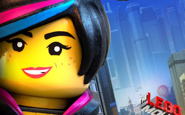 HD PC wallpaper showing Wyldstyle (The LEGO Movie) LEGO minifigure close-up, neon-trimmed hair and freckles, city skyline behind and The LEGO Movie logo text visible in the background.