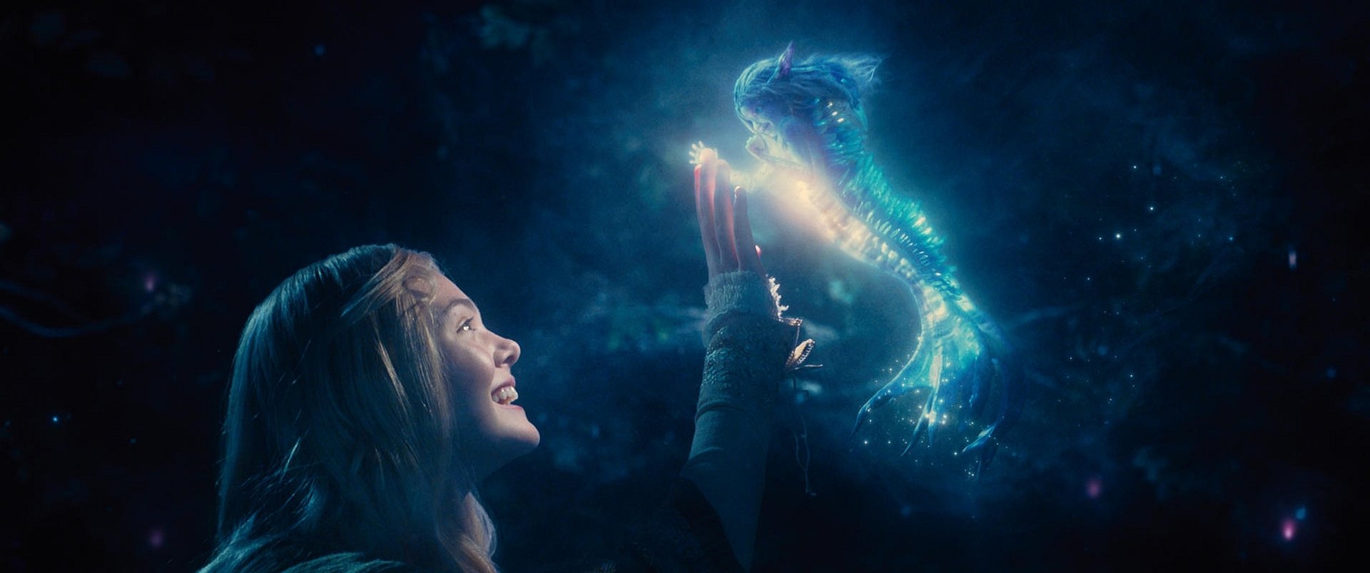 HD PC desktop wallpaper from the movie Maleficent, featuring a young woman reaching out to a glowing, magical dragon in a dark, mystical setting.