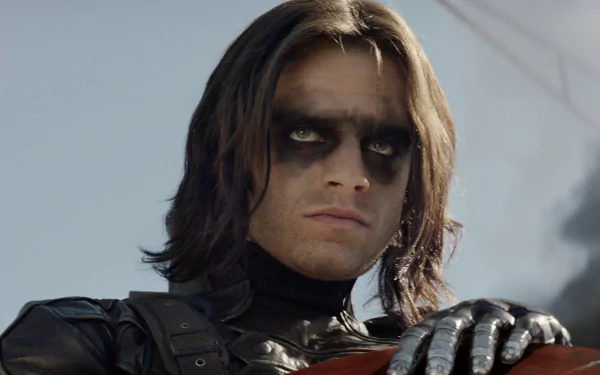 Sebastian Stan as the Winter Soldier, showcasing his intense gaze and iconic look from the movie Captain America: The Winter Soldier in a striking HD desktop wallpaper.