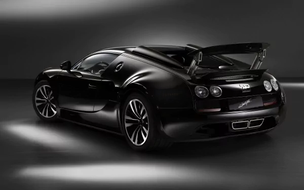 Black Bugatti Veyron Grand Sport Vitesse in dramatic studio lighting, 2K Quad HD PC desktop wallpaper showcasing the high-performance vehicle.