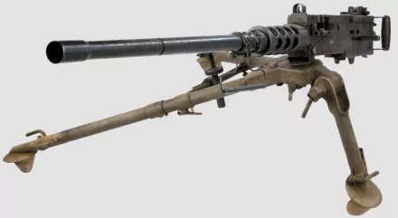 High-definition image of a machine gun set against a neutral background, showcasing its intricate details and man-made design, suitable as a striking desktop wallpaper.