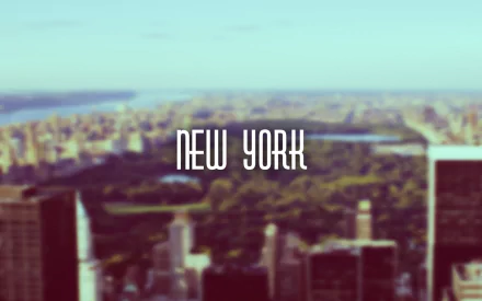 Minimalist HD desktop wallpaper featuring a blurred aerial photograph of New York City with New York in clean, modern typography centered in the image.