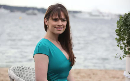 HD PC desktop wallpaper featuring English actress and celebrity Hayley Atwell smiling outdoors by the water.