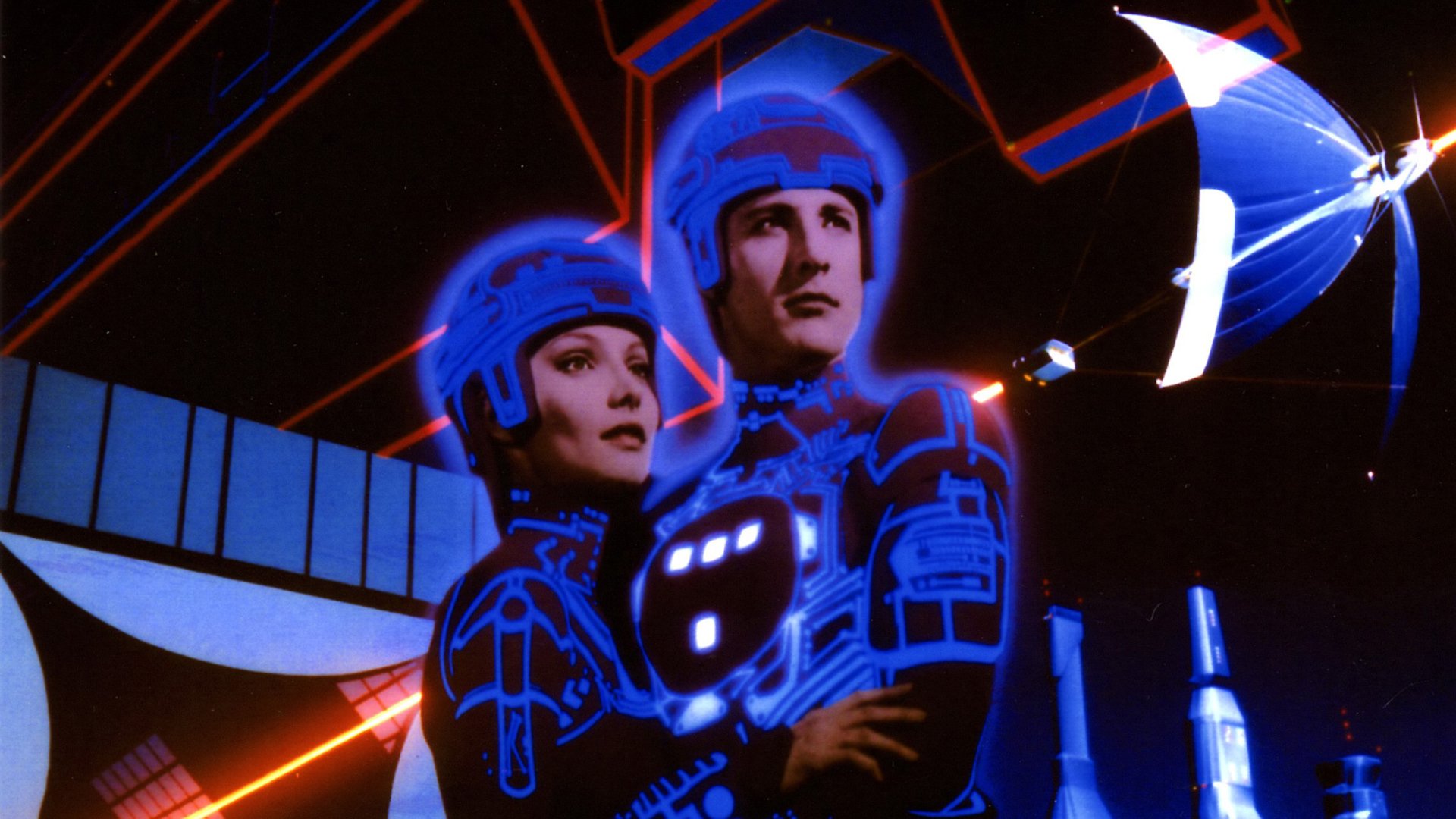 HD PC desktop wallpaper featuring characters from the movie Tron, illuminated with glowing blue circuitry against a dark, futuristic background.