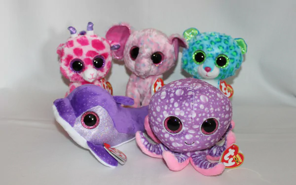 A colorful collection of Beanie Boos, featuring a pink giraffe, an elephant, a green bear, a purple octopus, and a dolphin, set against a light background in a 4K Ultra HD wallpaper.