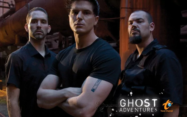 HD PC desktop wallpaper of the TV show Ghost Adventures: three figures in black shirts pose amid rusted industrial pipes, the Ghost Adventures logo visible at the bottom.