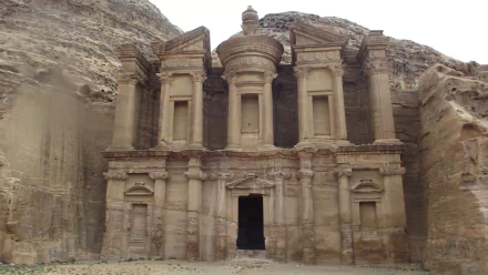 HD desktop wallpaper showcasing the iconic man-made rock-cut structure of Petra, carved into a sandstone cliff with intricate architectural details.