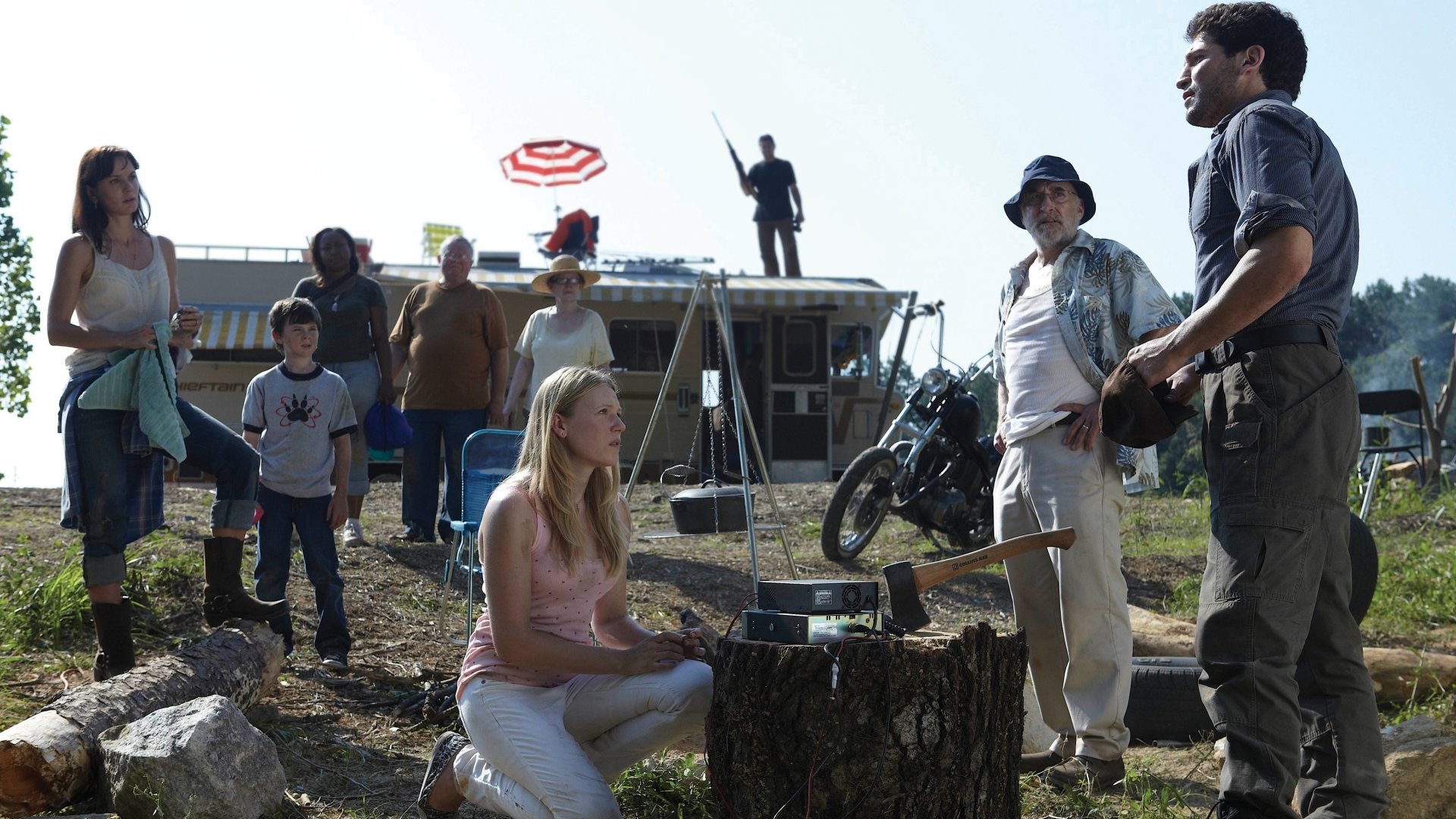 4K Ultra HD desktop wallpaper featuring a tense scene from The Walking Dead TV show with characters gathered outdoors near a motorhome under a bright sky.