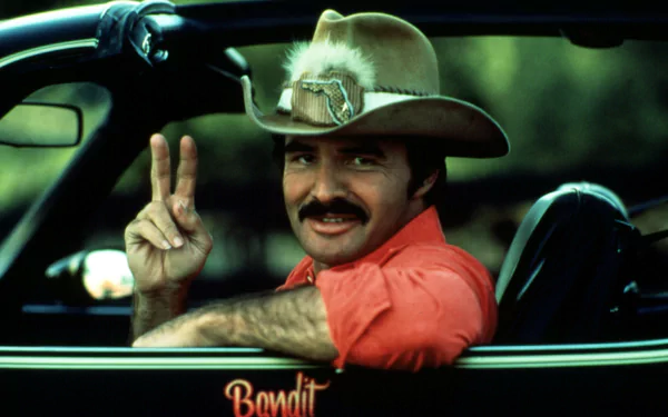 HD PC desktop wallpaper featuring a scene from the movie Smokey and the Bandit with the main character flashing a peace sign from a car window.
