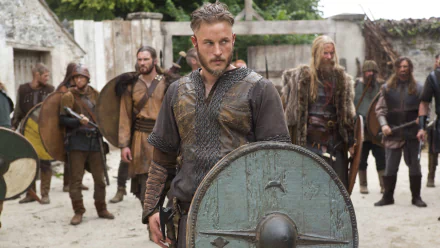 Scene from Vikings (2013) TV show featuring a warrior holding a weathered shield, surrounded by similarly armored men, rendered in 4K Ultra HD for PC desktop wallpaper.