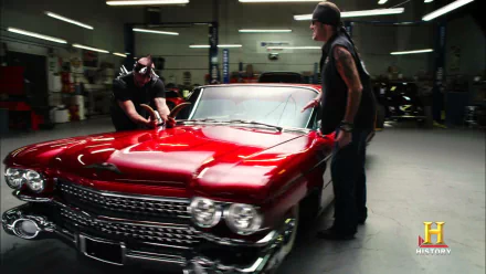 HD desktop wallpaper featuring a vibrant red classic car from the TV show Counting Cars in a well-lit garage setting.