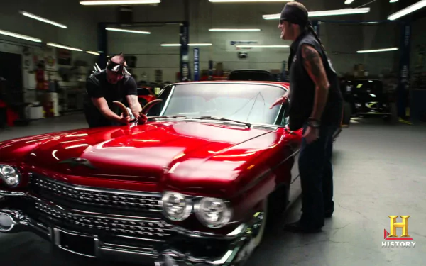HD desktop wallpaper featuring a vibrant red classic car from the TV show Counting Cars in a well-lit garage setting.