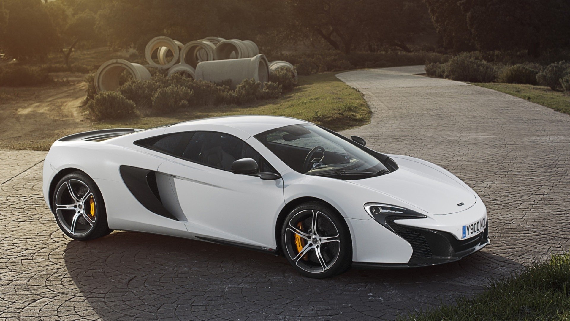 White car McLaren 650S supercar parked on a stone driveway at sunset — HD PC desktop wallpaper background of the sleek vehicle.