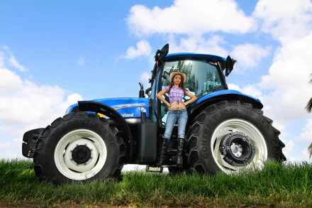 A New Holland tractor stands in a lush green field, with a woman confidently posed beside it under a bright blue sky, creating a vibrant HD desktop wallpaper.