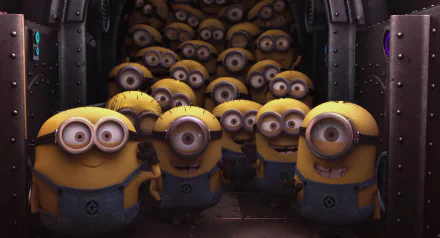 A HD desktop wallpaper featuring an image from the movie Despicable Me with a group of cheerful Minions in their signature blue overalls, standing together in a metallic room.