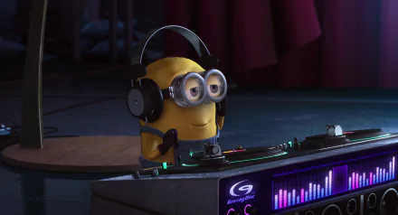 HD wallpaper featuring a Minion from the movie Despicable Me wearing headphones and operating DJ equipment with a graphically lit control panel in the background.
