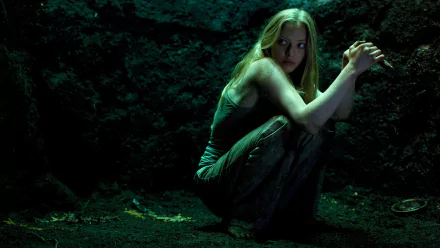 4K Ultra HD PC desktop wallpaper: a tense female lead crouches in a shadowy, mossy cave, clutching her arms — cinematic still from the movie Gone.