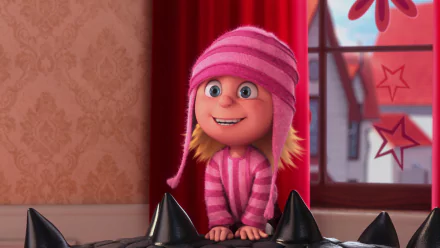 Edith from Despicable Me 2 is featured in this HD desktop wallpaper, showcasing her playful smile and cozy pink striped outfit against a vibrant background.
