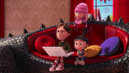 HD PC desktop wallpaper featuring Margo, Agnes, and Edith from Despicable Me 2 sitting on a black dragon-shaped couch in a cozy, colorful room.