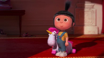 Agnes from Despicable Me stands joyfully with her plush unicorn in this vibrant HD wallpaper from Despicable Me 2, capturing her playful spirit and charm.