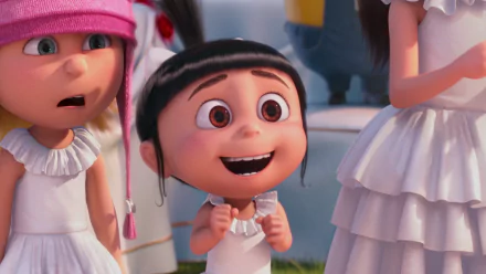 HD wallpaper featuring Edith and Agnes from Despicable Me 2. Agnes stands excitedly in the center with a big smile, while Edith looks surprised on the left, both dressed in white.