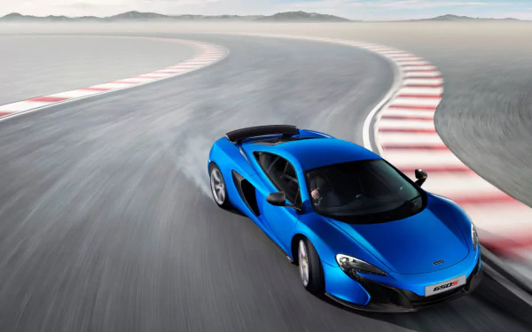 A vibrant blue McLaren 650S supercar speeding on a race track, captured in high definition for a stunning PC desktop wallpaper background.