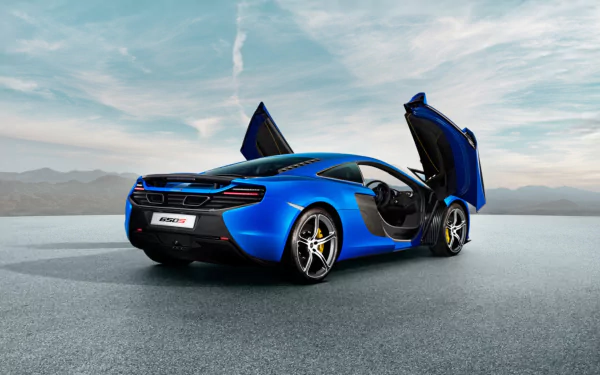 HD desktop wallpaper featuring a blue McLaren 650S supercar with its butterfly doors open, set against a scenic, expansive backdrop.