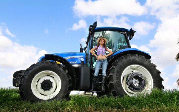 A New Holland tractor stands in a lush green field, with a woman confidently posed beside it under a bright blue sky, creating a vibrant HD desktop wallpaper.