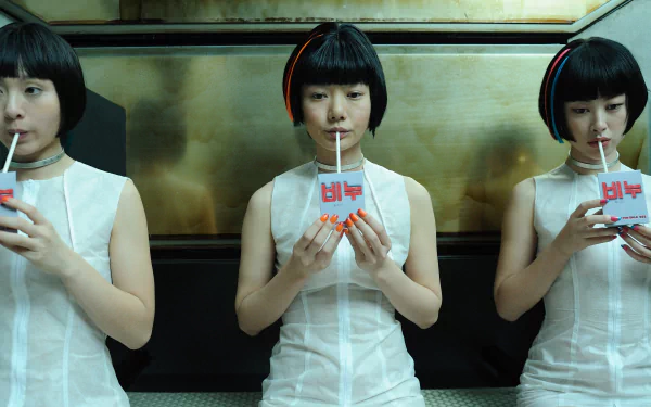 Cloud Atlas movie 2K Quad HD PC desktop wallpaper: three identical women in white sleeveless dresses with bob cuts, seated against a metallic wall, each sipping from a straw.