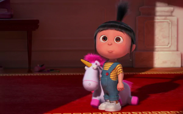 Agnes from Despicable Me stands joyfully with her plush unicorn in this vibrant HD wallpaper from Despicable Me 2, capturing her playful spirit and charm.