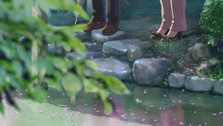 HD desktop wallpaper from The Garden of Words featuring a close-up of two characters' legs as they stand on stepping stones surrounded by lush greenery and pink petals.