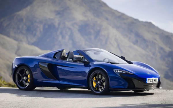 A blue McLaren 650S Spider supercar parked with mountains in the background, showcased as an HD PC desktop wallpaper and background.