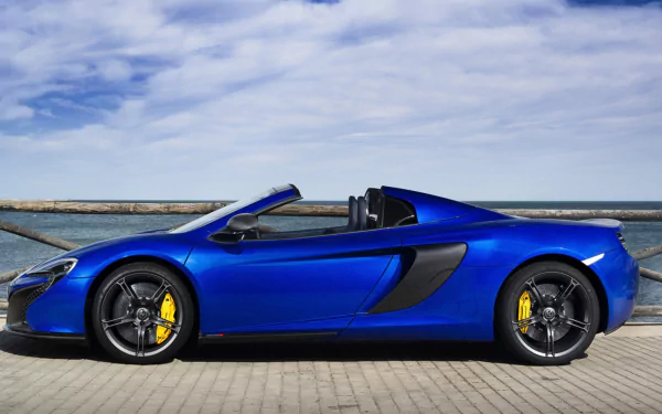 Blue McLaren 650S Spider supercar convertible car parked by the waterfront under a cloudy sky — HD PC desktop wallpaper/background.