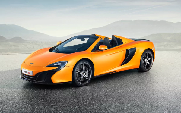 Orange McLaren 650S Spider supercar parked on an open road with mountains in the background, captured in HD for a desktop wallpaper.