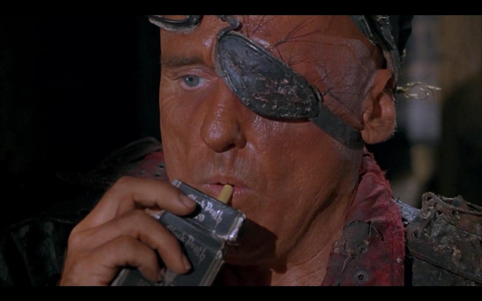 HD PC desktop wallpaper from the movie Waterworld, featuring a close-up of a character with an eye patch drinking from a flask.