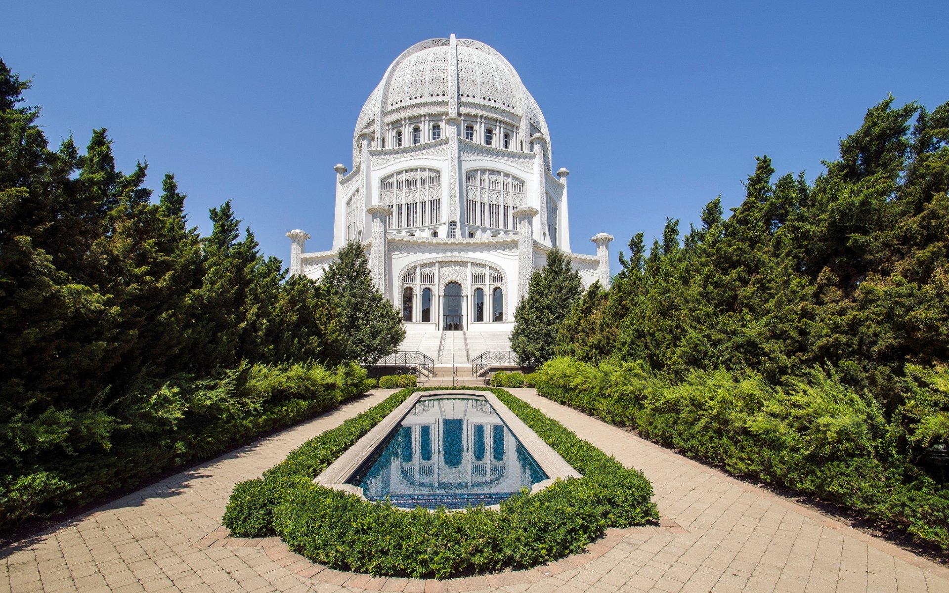 HD PC desktop wallpaper background: frontal view of the white Baha'i Temple dome with reflecting pool, trimmed green hedges and a clear blue sky — religious site.