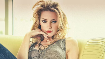 A stunning HD wallpaper featuring Amber Heard, showcasing her relaxed pose with tousled hair and a casual outfit, set against a soft, light background.