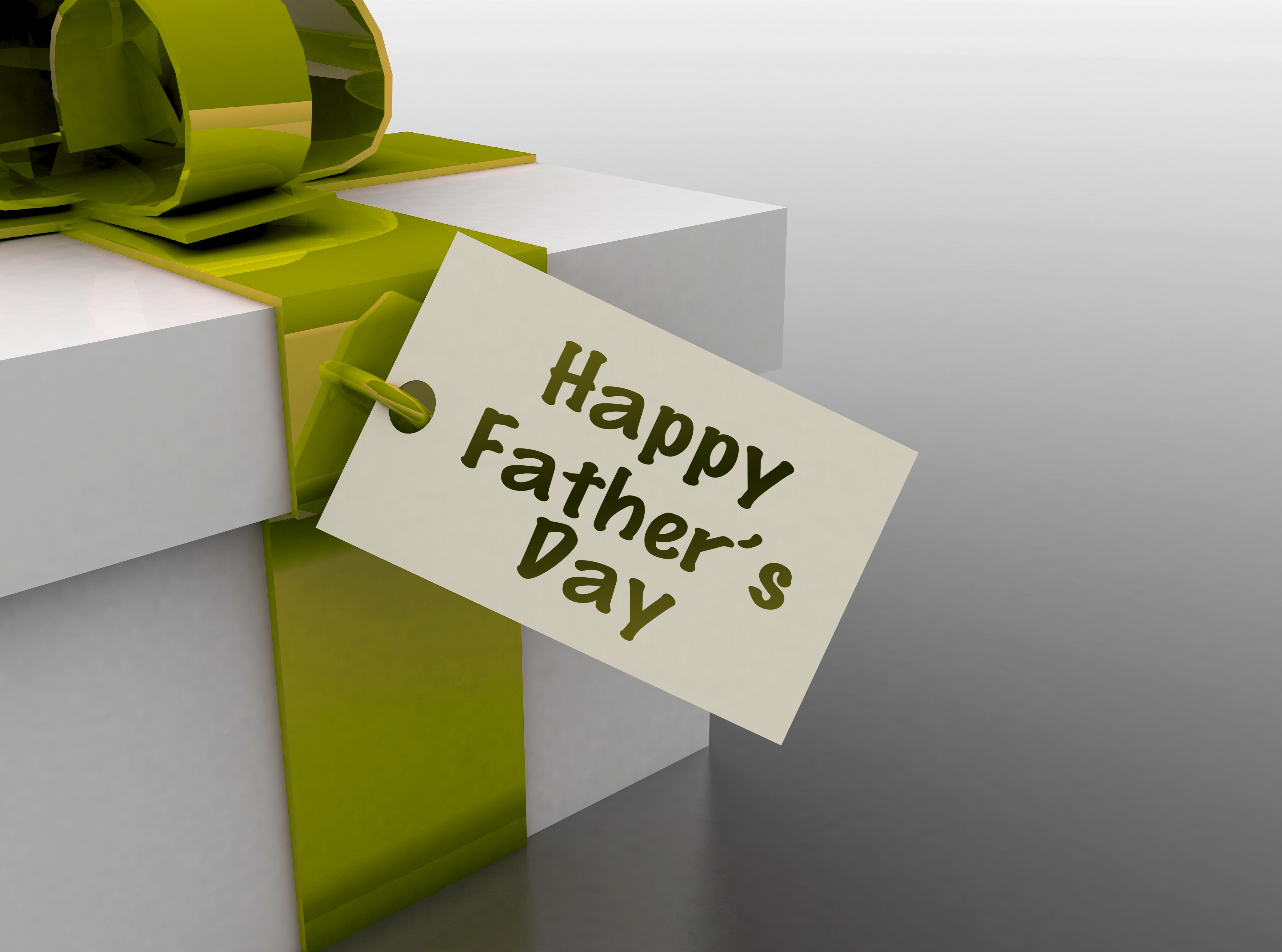 A HD wallpaper featuring a gift with a green ribbon and a tag that reads Happy Father's Day.