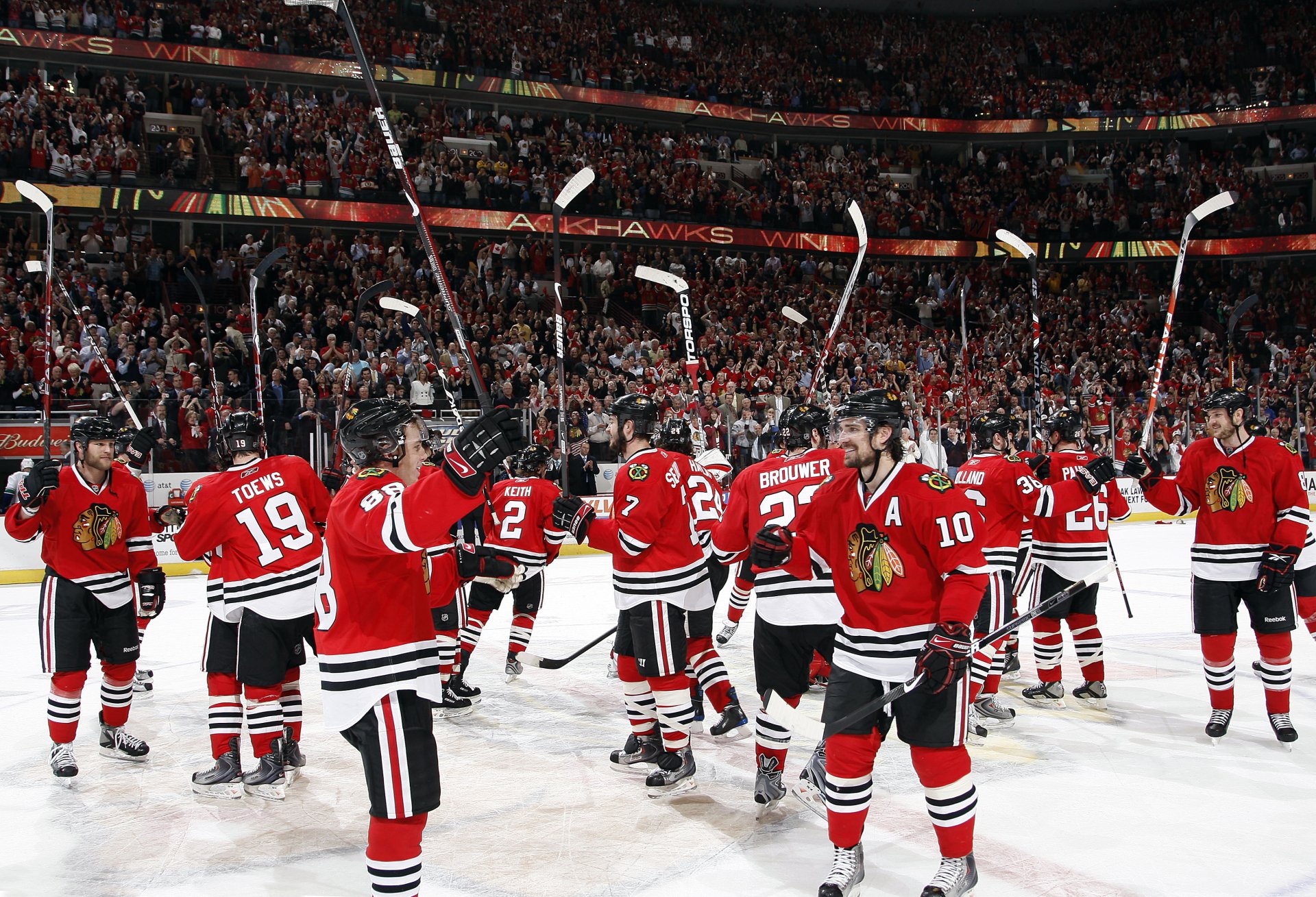 Chicago Blackhawks hockey team on ice celebrating, HD wallpaper for desktop background.