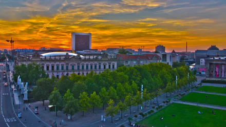 A stunning HD desktop wallpaper showcasing Berlin at sunset, featuring vibrant skies, lush greenery, and a blend of modern and historical architecture.