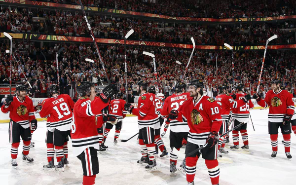 Chicago Blackhawks hockey team on ice celebrating, HD wallpaper for desktop background.