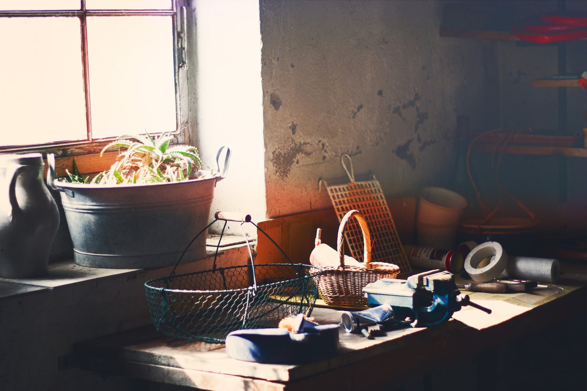 A vintage-style photography scene of a rustic windowsill with various baskets and household items, captured in 4K Ultra HD for PC desktop wallpaper and background.