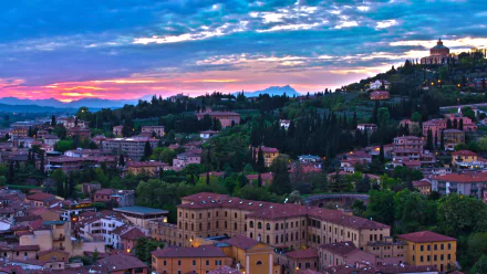 HD desktop wallpaper showcasing a panoramic view of man-made buildings and lush greenery in Verona under a vibrant twilight sky.