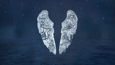 A mesmerizing HD wallpaper featuring ethereal wings, inspired by Coldplay's music, set against a serene night sky and tranquil water backdrop.
