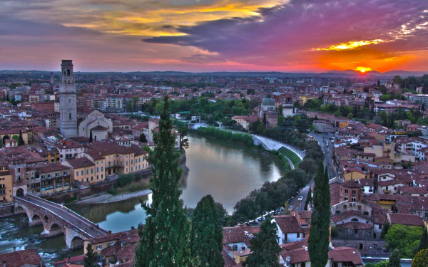 HD desktop wallpaper of Verona showcasing historic man-made architecture along the river at sunset with colorful skies.