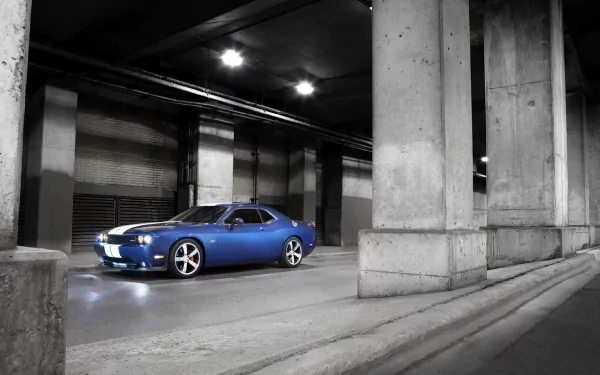 Blue Dodge Challenger SRT8 muscle vehicle in a concrete underpass, HD PC desktop wallpaper background with headlights glowing.