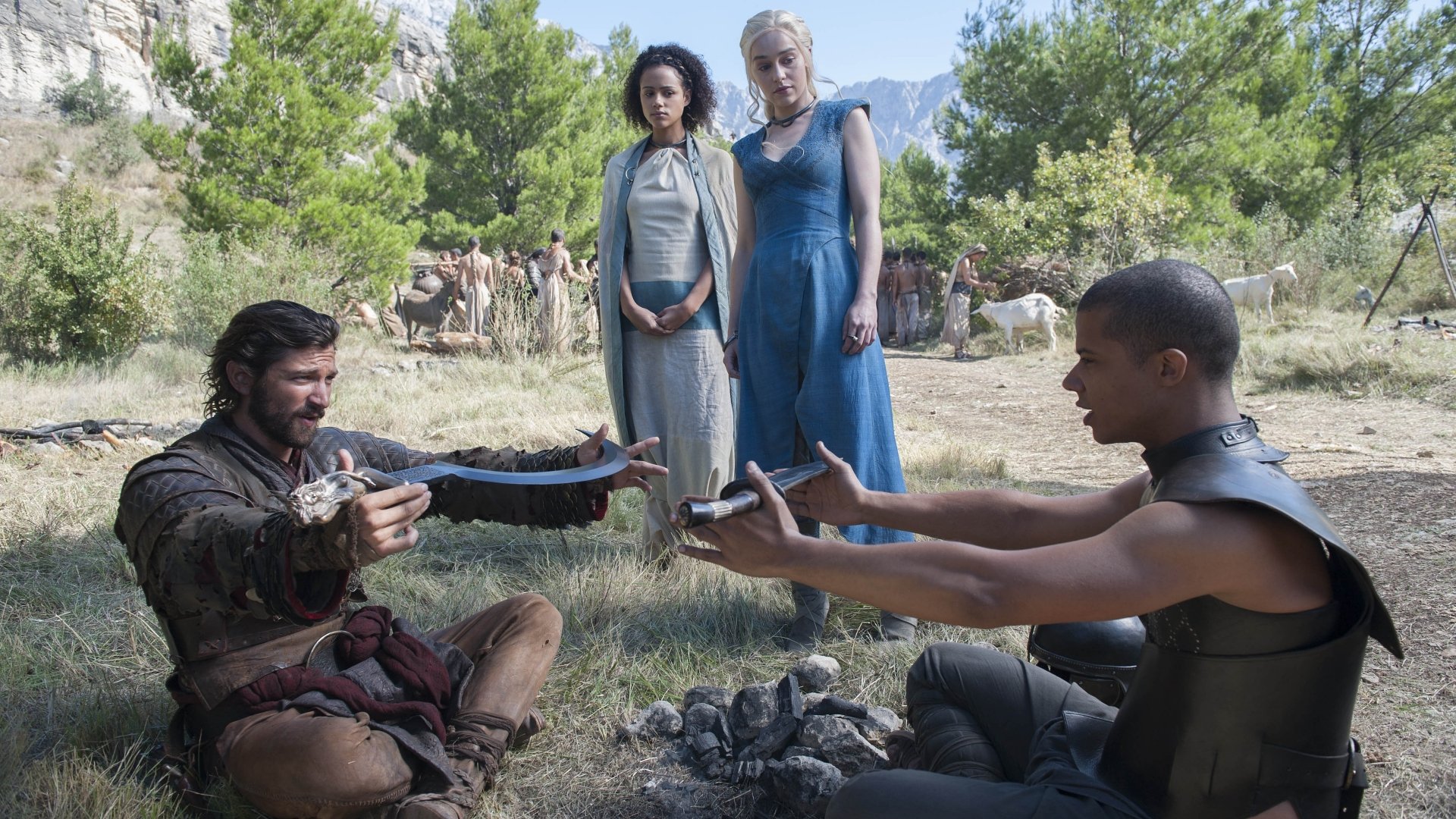 A scene from Game of Thrones featuring Daenerys Targaryen, Grey Worm, Missandei, and Daario Naharis in a dramatic standoff in a sunlit outdoor setting. 4K Ultra HD wallpaper.