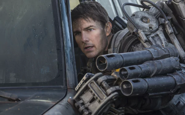 Tom Cruise in a gripping moment from the movie Edge of Tomorrow, featuring intense action and a futuristic weapon. A striking 4K Ultra HD desktop wallpaper.