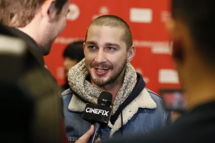Shia LaBeouf smiling during an interview, suitable as a high-definition desktop wallpaper.